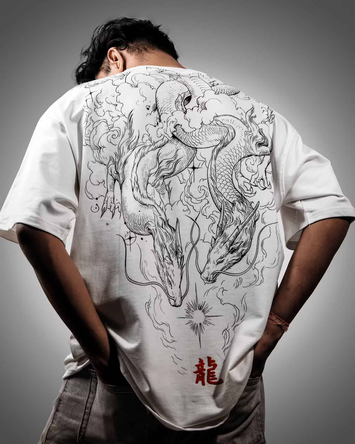 Man showcasing the back of the Spacered Ryu t-shirt